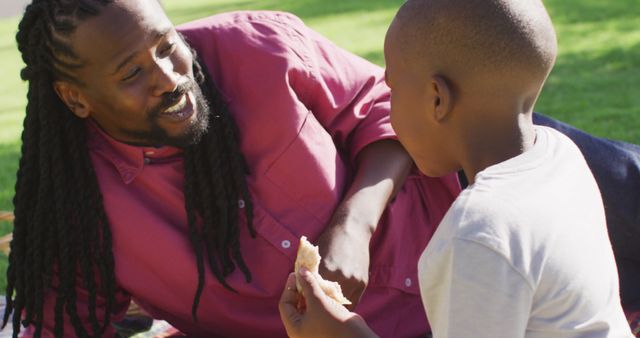 Father and son enjoying picnic outdoors on sunny day - Download Free Stock Images Pikwizard.com