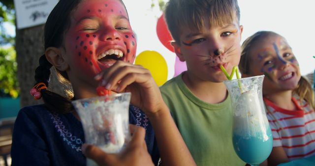 Kids with Face Paint Drinking Colorful Beverages at Outdoor Party - Download Free Stock Images Pikwizard.com