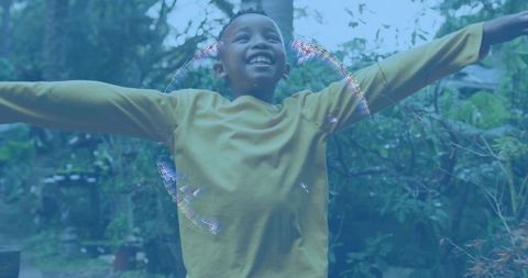 Radiant joyful african american boy stretching arms garden mustard shirt with bubble halo