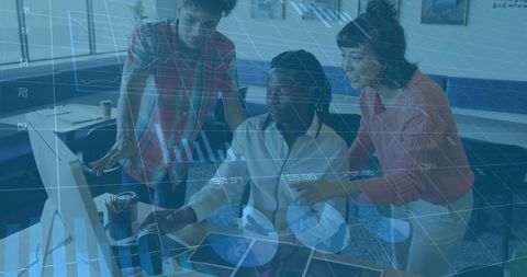 Diverse Team Collaborating Over Digital Analytics in Modern Office