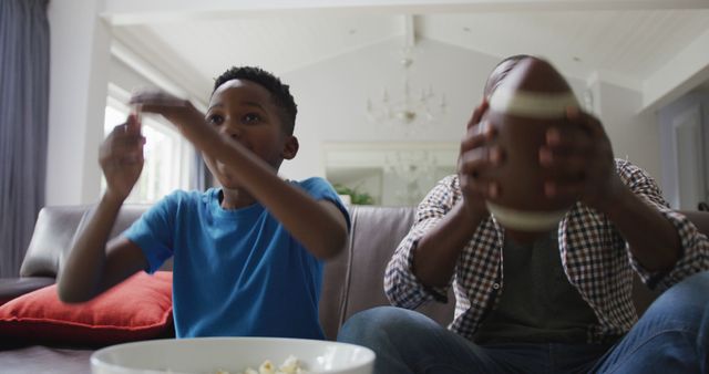 Father and Son Watching Football on TV at Home - Download Free Stock Images Pikwizard.com