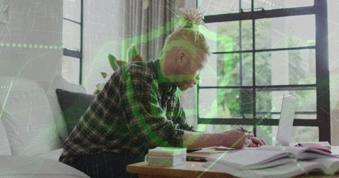 Concentrated Writer at Home with Laptop and Notebook