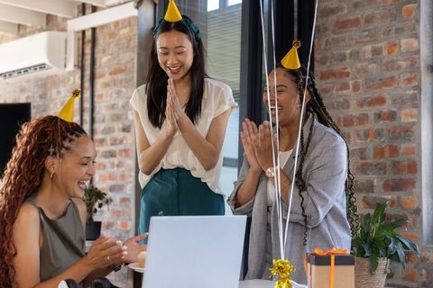 Happy business team celebrating with birthday party in office