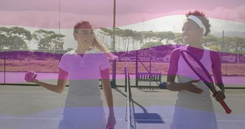 Young female tennis players chatting on outdoor hard court
