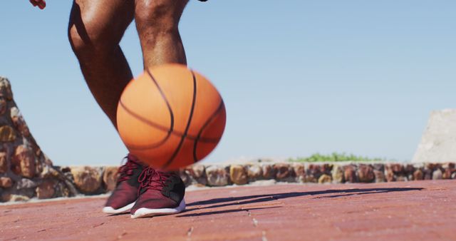 Athlete dribbling basketball outdoors on sunny day - Download Free Stock Images Pikwizard.com