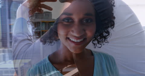 Joyful Woman's Reflection Overlaying Urban Background Detail