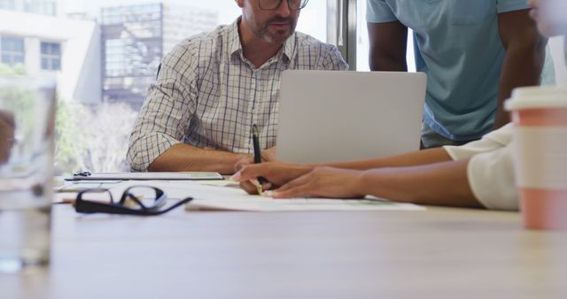 Team Meeting in Modern Office with Laptop and Documents - Download Free Stock Images Pikwizard.com