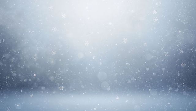 Gentle falling snow with bokeh lights and floating snowflakes on frosted blue background