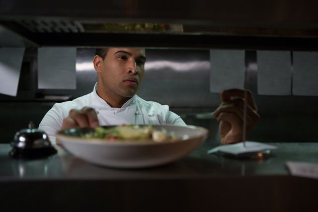 Chef looking at an order list in the commercial kitchen at restaurant