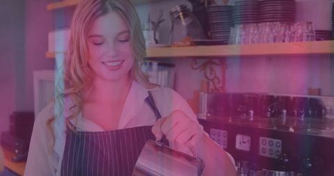 Smiling barista preparing steamed milk in cozy cafe
