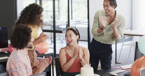 Diverse team celebrating birthday in office environment