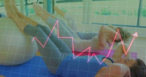 Women exercising with stability balls beside financial growth chart
