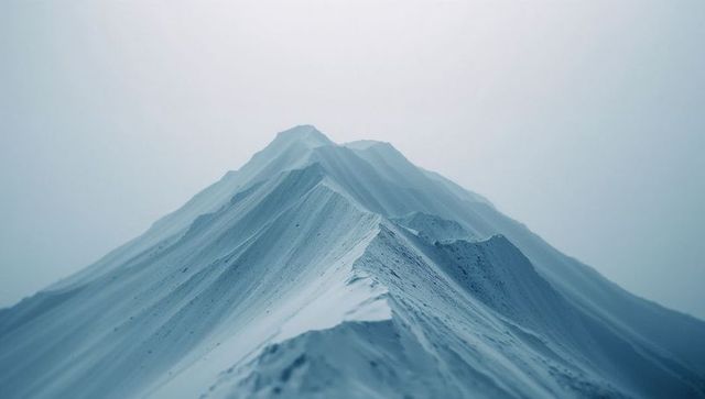 Serene Snow-Covered Mountain Ridge in Misty Winter Scene