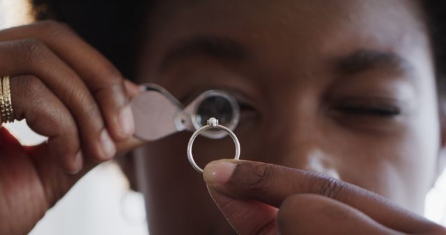 Jewelry appraiser examining diamond ring with magnifying glass - Download Free Stock Images Pikwizard.com