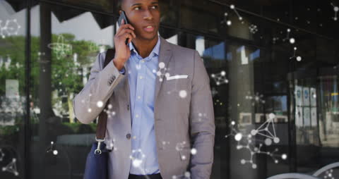 Businessman Engaging in Mobile Communication with Digital Graphics