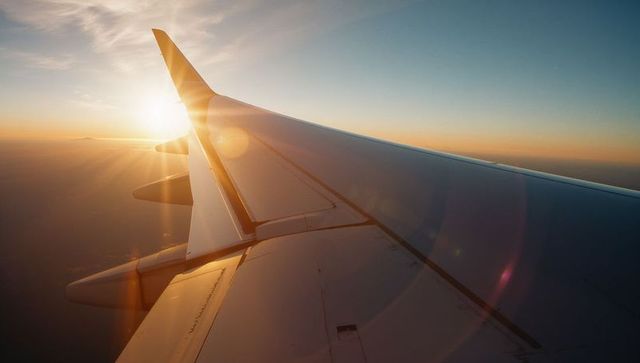 Serene Sunset from Airplane Wing at High Altitude View