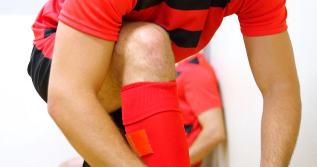 Soccer Player Tying Cleats in Locker Room - Download Free Stock Images Pikwizard.com