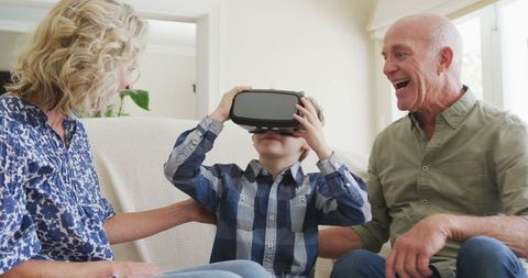 grandparents spending time with grandson using vr headset - Download Free Stock Images Pikwizard.com