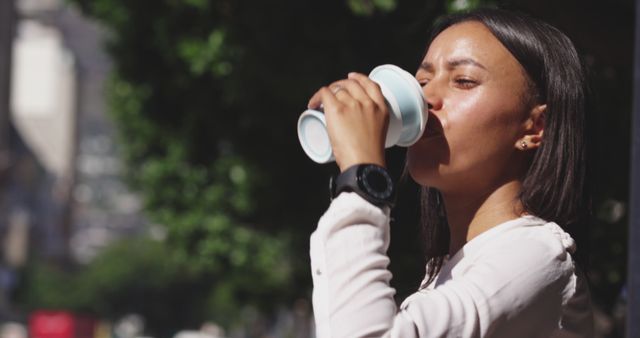 Young Woman Drinking Coffee Outdoors in Urban Setting - Download Free Stock Images Pikwizard.com