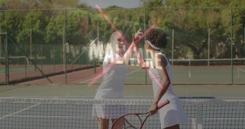 Celebratory High-Five Between Tennis Players on Green Court