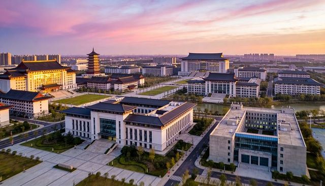 Aerial dusk view of modern university campus with traditional tiled roofs and pagoda