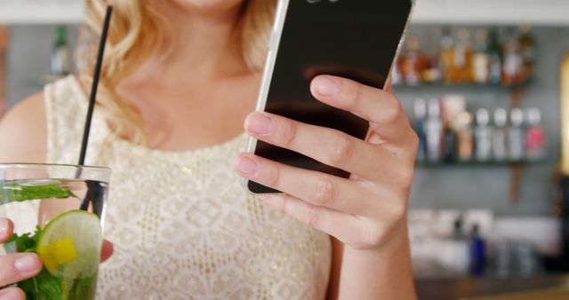 Woman in Summer Dress Texting and Holding Refreshing Drink - Download Free Stock Images Pikwizard.com