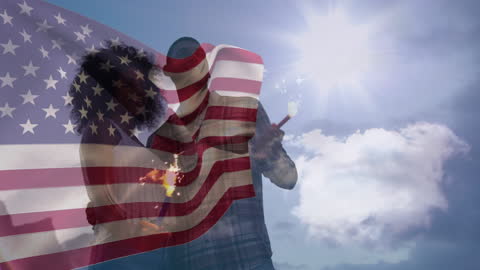 Waving USA Flag with Friends Holding Sparklers on Sunny Beach