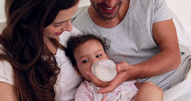 Young Parents Feeding Baby with Bottle at Home - Download Free Stock Images Pikwizard.com