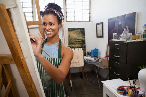 Woman Artist Joyfully Painting on Canvas in Art Studio - Download Free Stock Images Pikwizard.com
