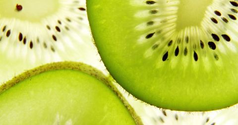 Vibrant close-up of kiwi slices with superimposed heart icons captures fresh fruit in a fun and artistic manner. Emphasizes health, vegetarian lifestyle, and nutritional benefits. Ideal for articles, blog posts, or advertisements highlighting fruits, healthy eating, national vegetarian celebrations, and eco-friendly themes.