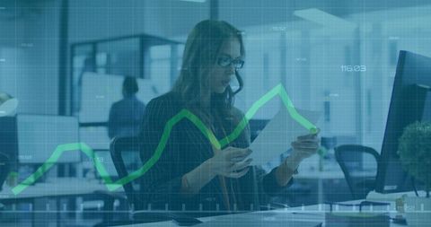 Woman reviewing financial documents with data analytics overlay in modern office