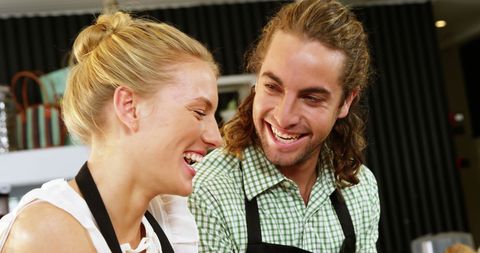 Friendly Cafe Staff Socializing Behind Counter