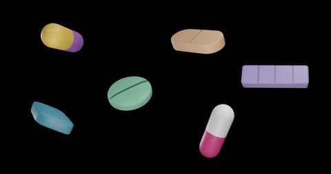 Floating Colorful Pills on Black Background Highlighting Medicine