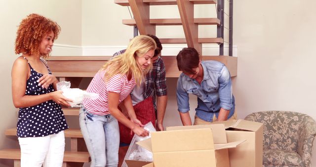 Group of Friends Unpacking Boxes in New Home - Download Free Stock Images Pikwizard.com