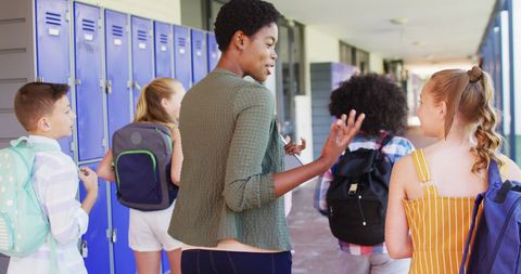 Teacher Guiding Students in School Hallway - Download Free Stock Images Pikwizard.com