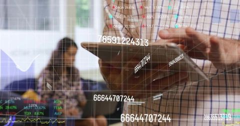 Professional steadying tablet while swiping financial analytics and data visualization