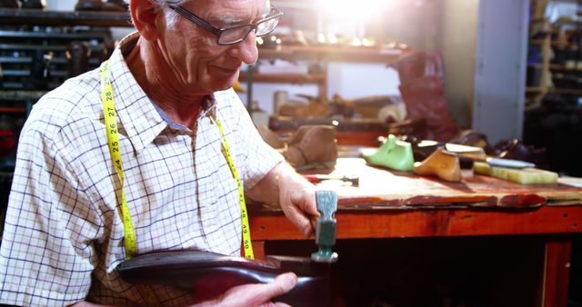 Senior shoemaker crafting custom leather shoe in workshop - Download Free Stock Photos Pikwizard.com