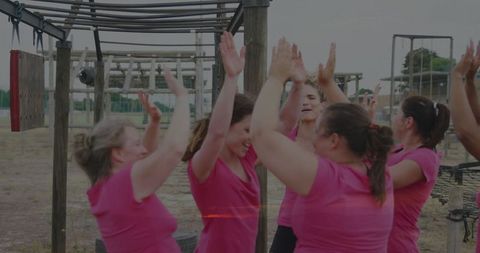 Women Celebrating Team Success at Outdoor Obstacle Course