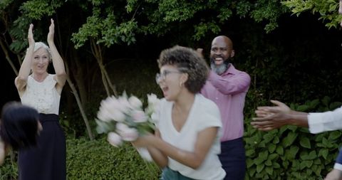 Joyful outdoor wedding celebration with family and friends