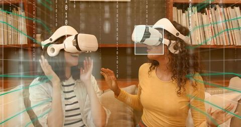 Friends exploring virtual reality on couch wearing white headsets with digital data overlay