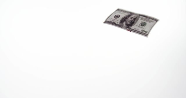 Hundred dollar bill appears to be floating against a white background. Ideal for financial blogs, investment illustrations, economic discussions, or business presentations. Can be used to depict wealth, cash flow, banking, or economic growth.