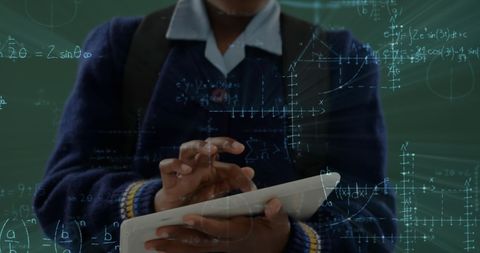 African American Schoolgirl Using Tablet with Math Animations on Chalkboard