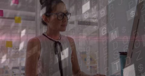 Asian Professional Analyzing Data on Monitor in Contemporary Office