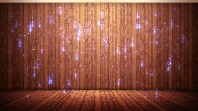 Glittering lights falling against wooden floor and wooden wall can be used for holiday, festive background, celebration, magical environments for events, promotion of warm, inviting spaces, or decorative wallpapers.