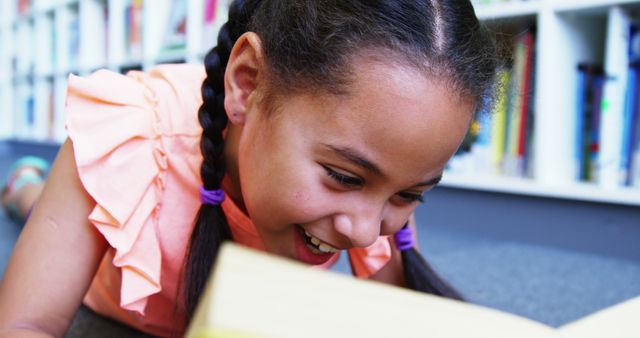 Smiling Young Girl Enjoying Book at School Library - Download Free Stock Images Pikwizard.com