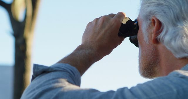 Senior Man Observing Through Binoculars Outdoors - Download Free Stock Images Pikwizard.com