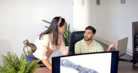 Colleagues collaborating on robotics project in office