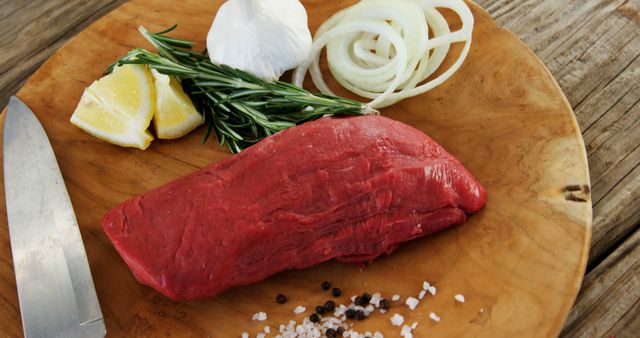 Preparing Fresh Beef Steak with Garlic, Onion, Lemon, and Rosemary - Download Free Stock Images Pikwizard.com