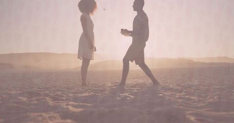 Couple at Sunset Beach with Proposal Gesture