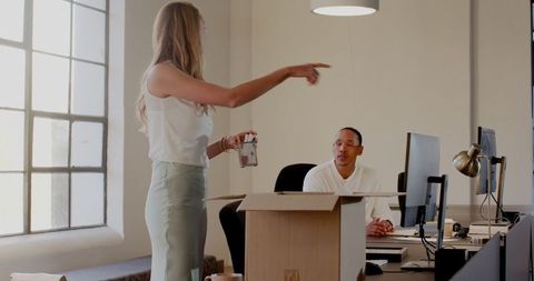 Colleagues Collaborating in Modern Office with Technology and Planning